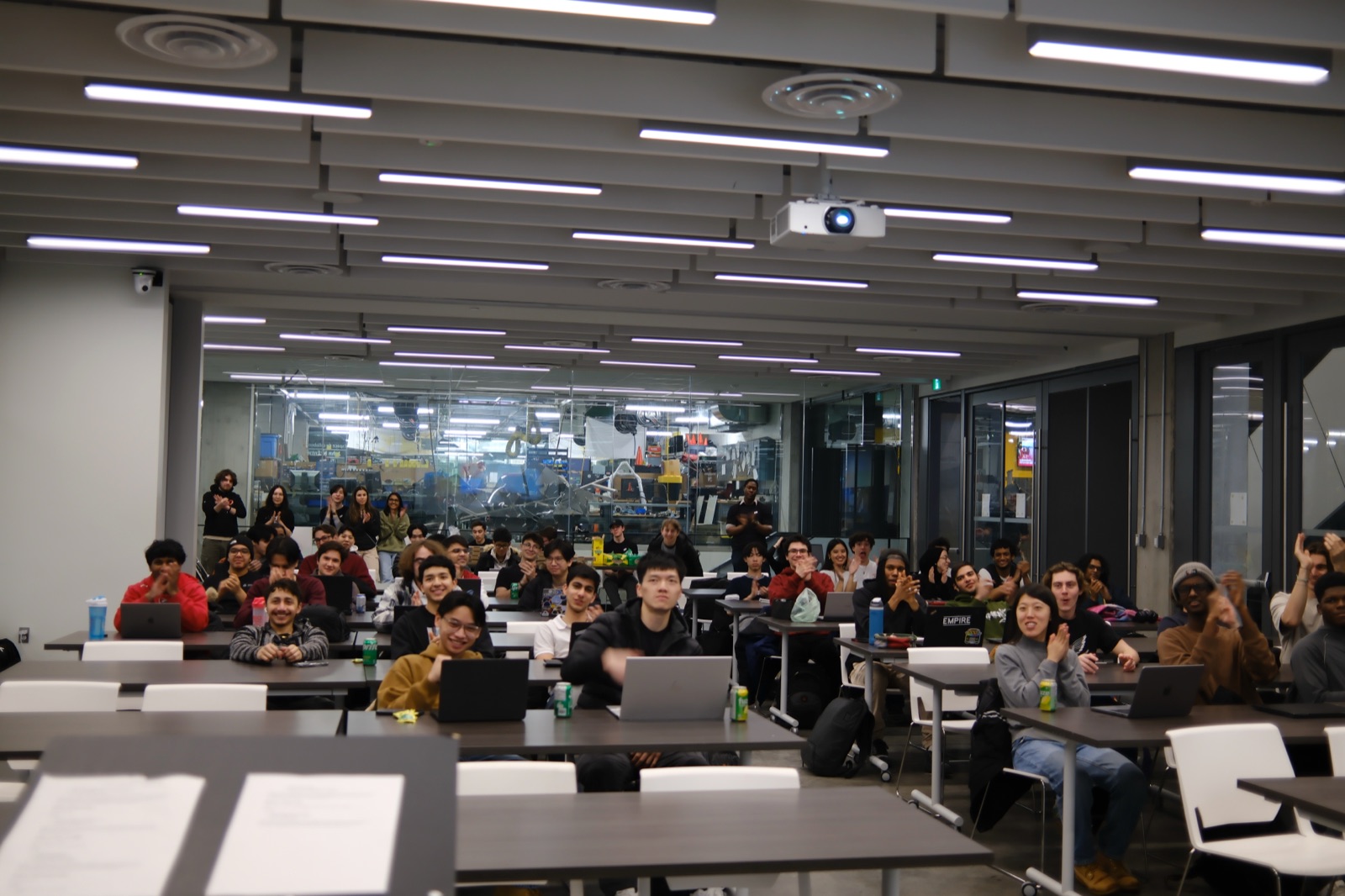 a full room of students applauding at the sesa x warp workshop