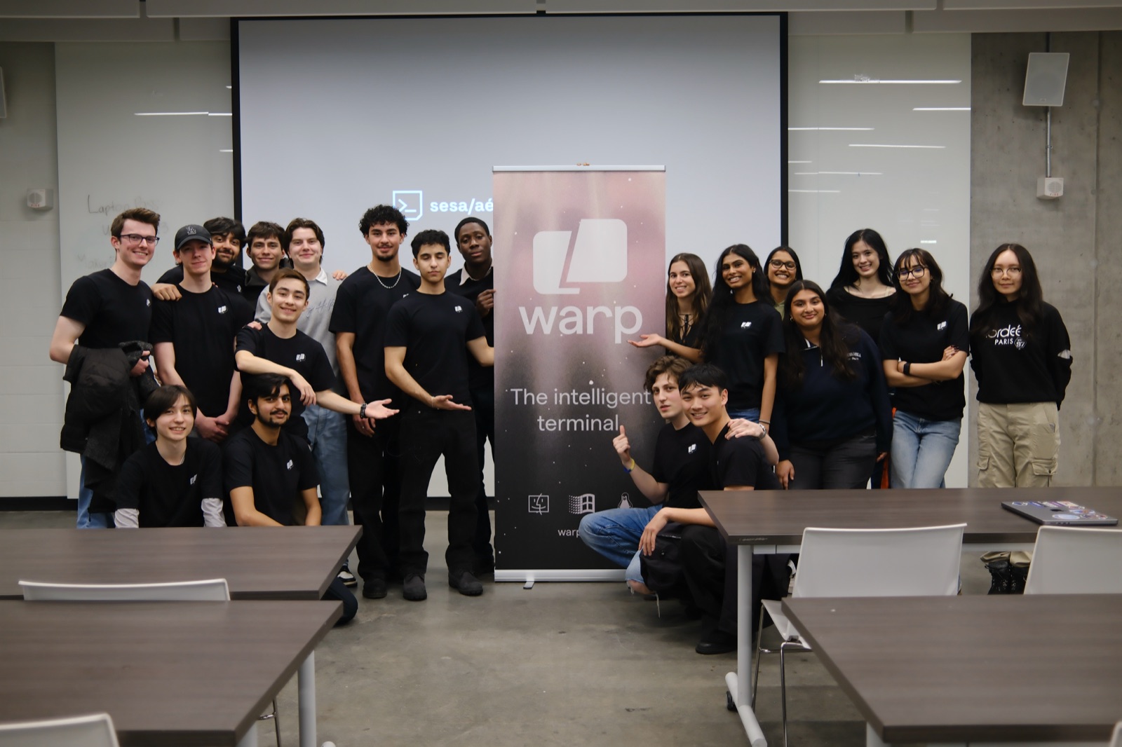 the sesa team posing around a warp banner after the workshop